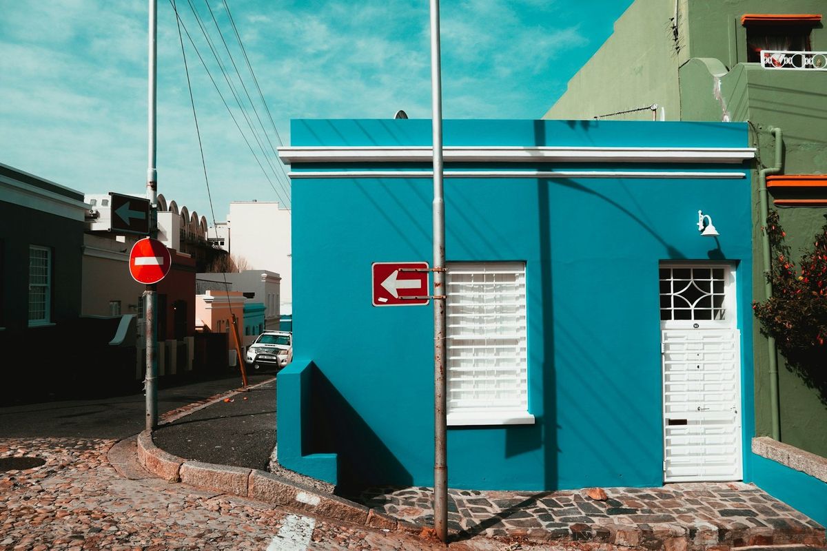 A turquoise corner house on a cobbled street in Bo-Kaap