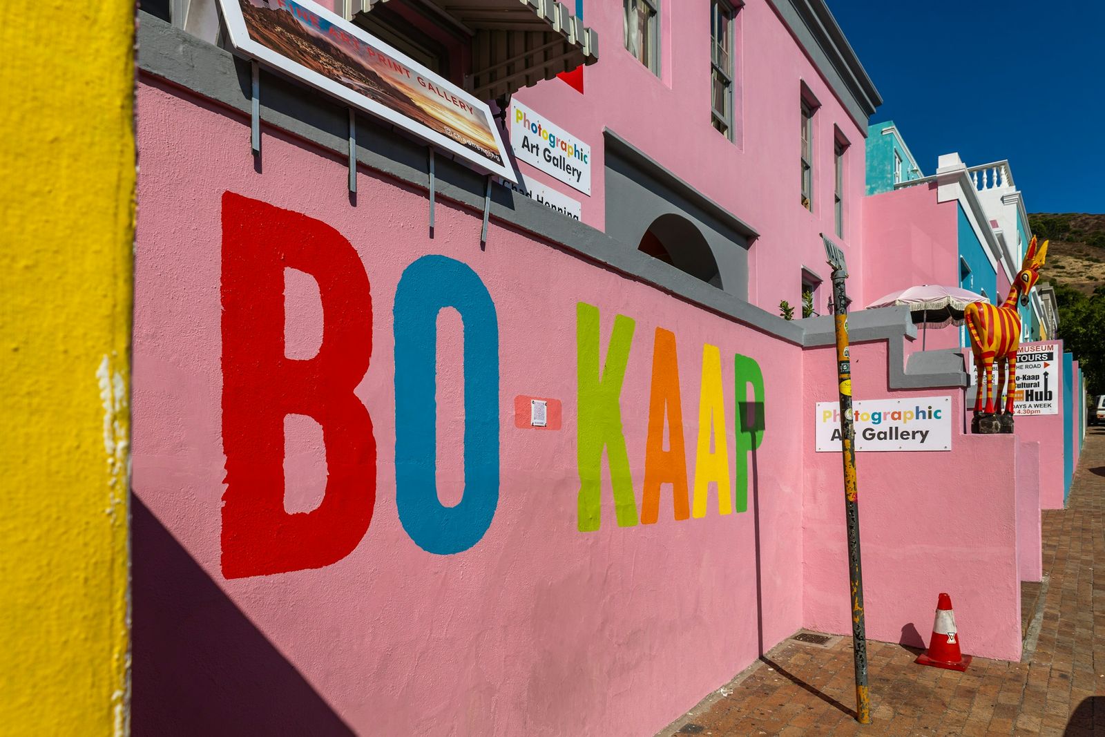 BO-KAAP painted in red, blue and green letters along a pink wall