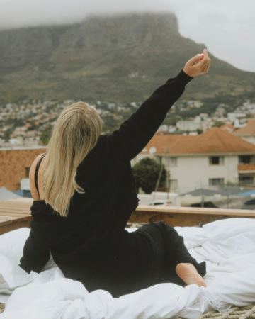 On the rope-net deck, an arm stretched out to Table Mountain