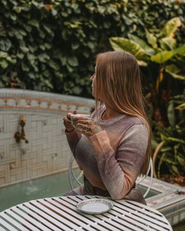 A cup of tea at the iron table by the wishing well
