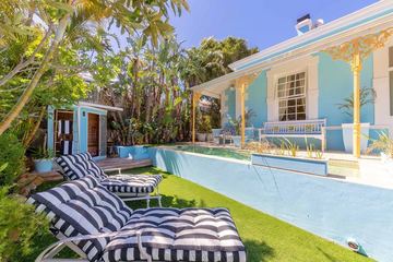 The garden, the pool and the verandah with its loungers