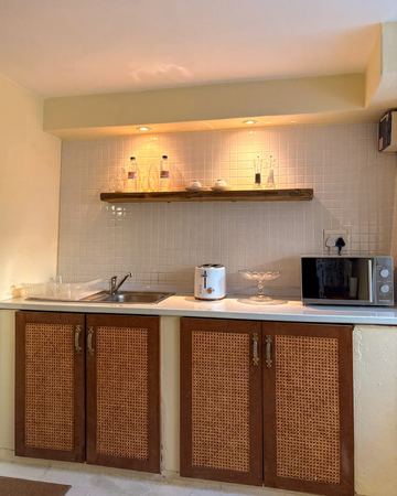 The Cottage Room: its kitchenette, lounge and bed
