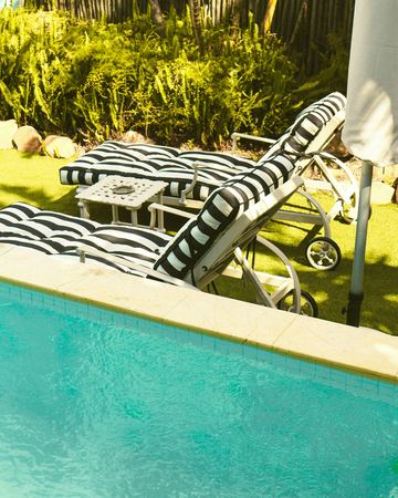 The pool and the striped loungers in the sun