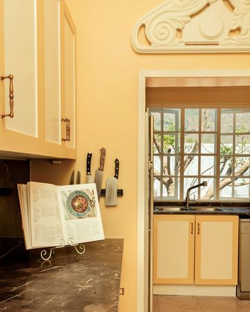The yellow kitchen, with a cookbook open